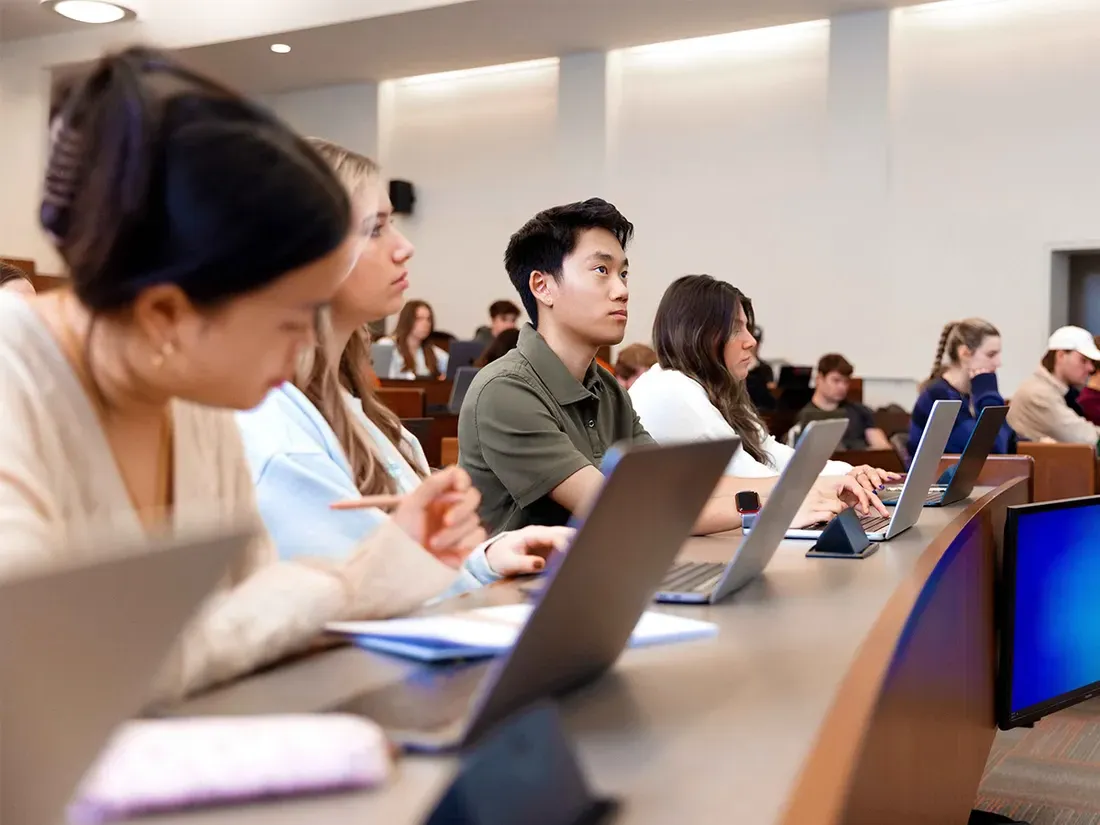 Students sitting at computers in classroom.